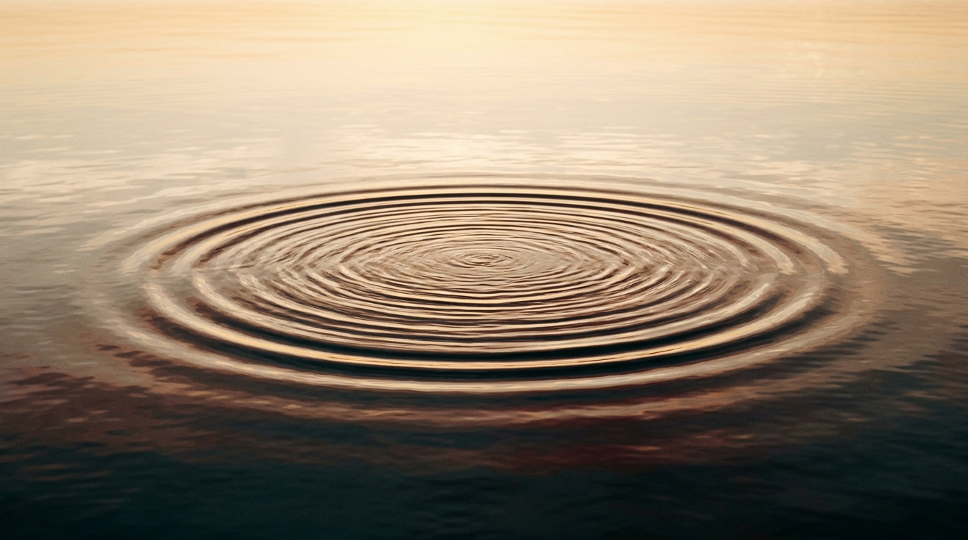 A single ripple expanding across calm, warm Gulf water at golden hour
